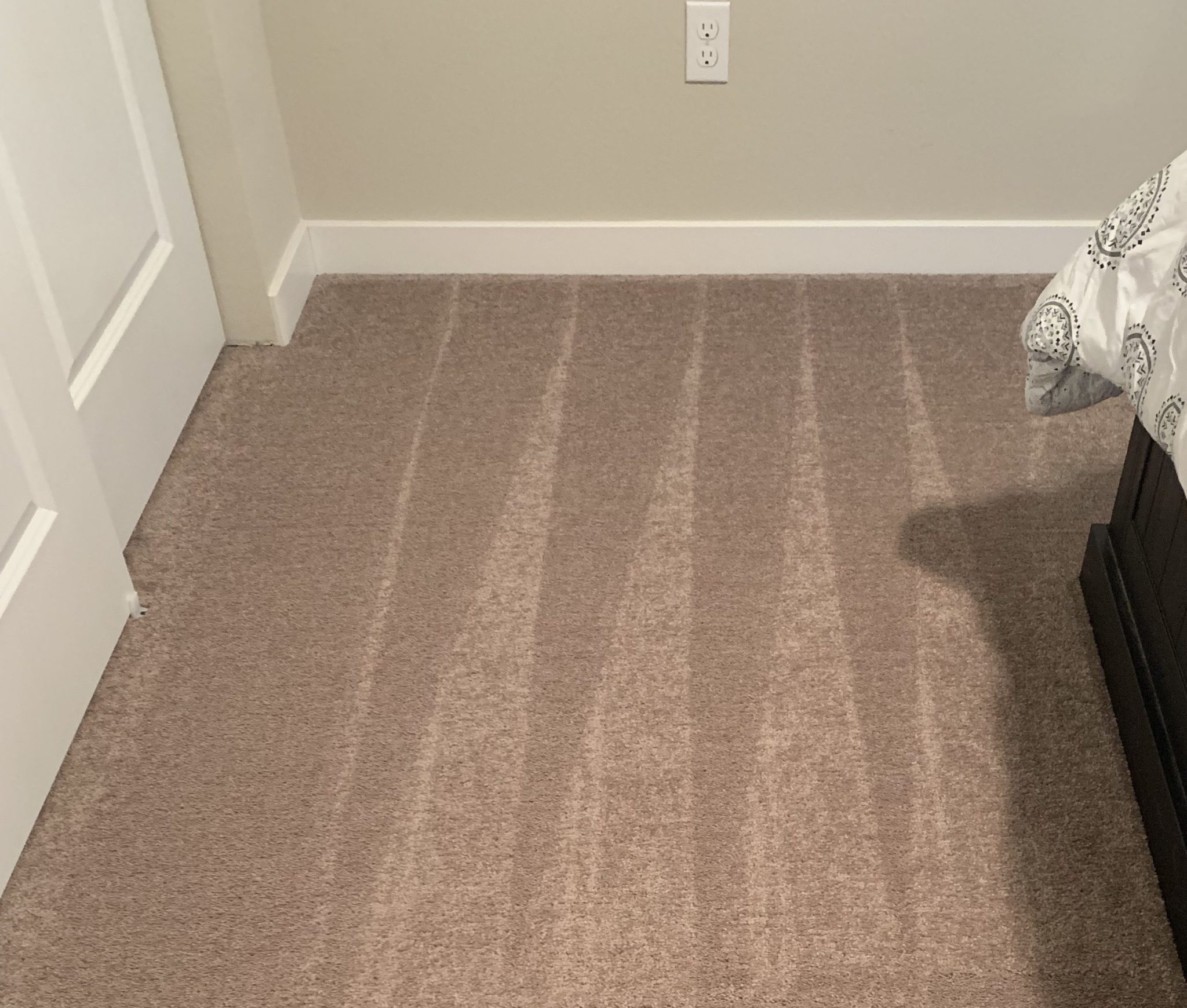 vacuum lines from freshly cleaned carpet in a bedroom